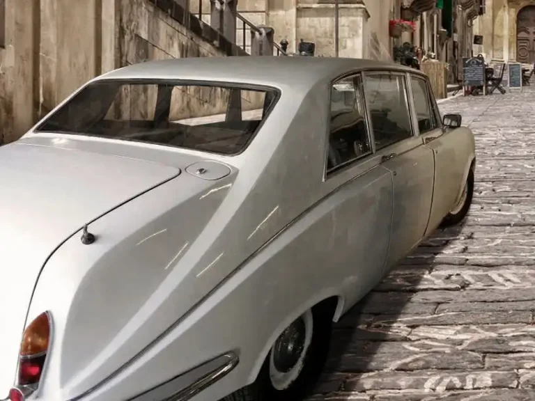 White Daimler DS420 Limousine rear view of car parked on the street